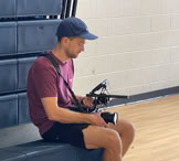 Close-up view of professional film equipment on a movie set with crew members preparing for filming.
